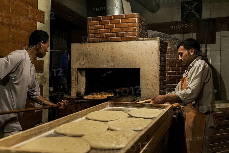 Tripoli, Libya, North Africa. Making traditional pita bread in an old bakery in the historic part of Tripoli
