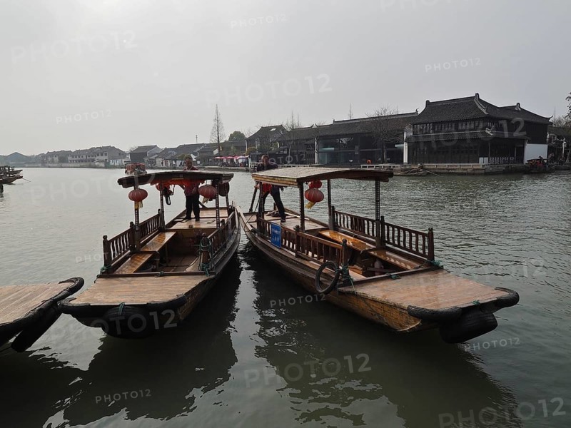 Two traditional boats with lanterns anchor on a quiet river in a Chinese city, Zhujiajiao Ancient Town, Shanghai, China