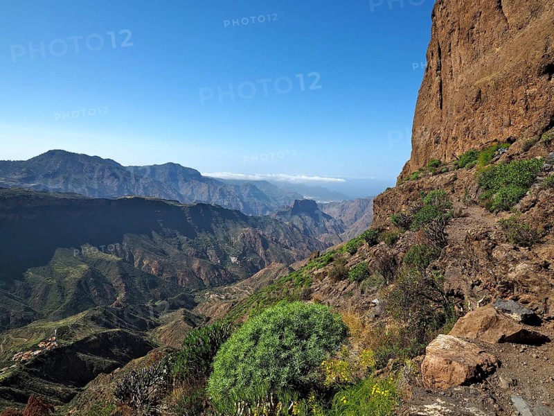View of a deep valley and distant mountains from a mountain trail, Roque Bentayga, Gran Canaria, Canary Islands, Canary Islands, Spain