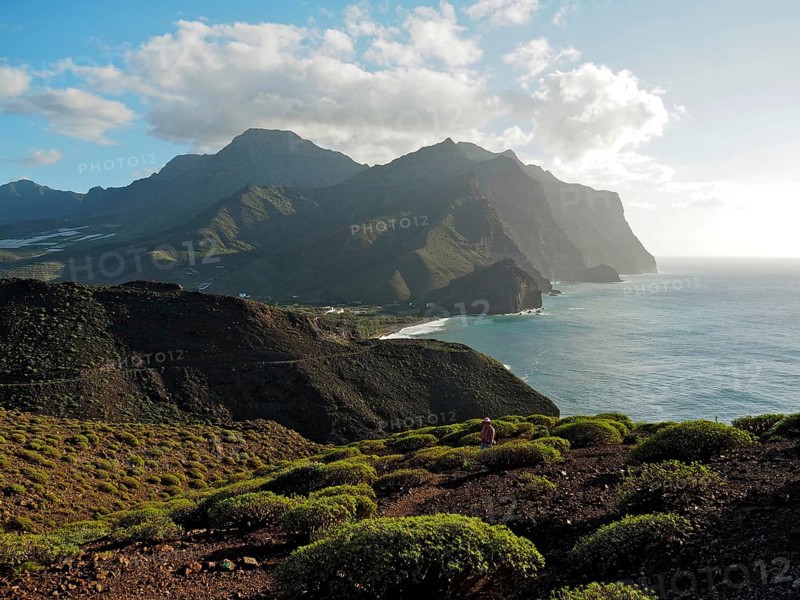 Coastal landscape with mountains and sea in soft light of evening sun, Puerto de la Aldea, Gran Canaria, Canary Islands, Spain