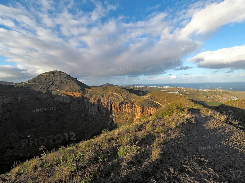 Range of hills under extended sky, widely visible sea in the background, Caldera de Bandama volcanic crater, Gran Canaria, Canary Islands, Canary Islands, Spain