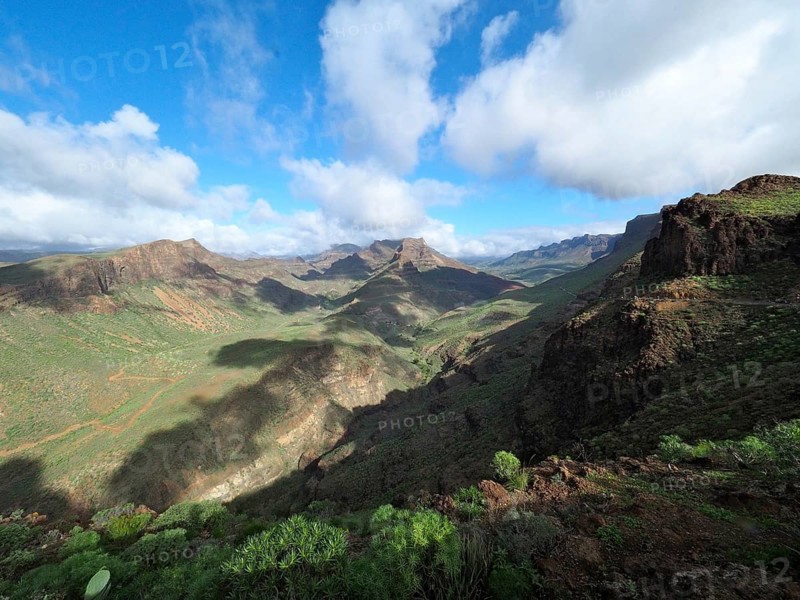 Wide mountain landscape with green valleys and dramatic cloudy sky, Barranco de Fataga, Gran Canaria, Canary Islands, Canary Islands, Spain
