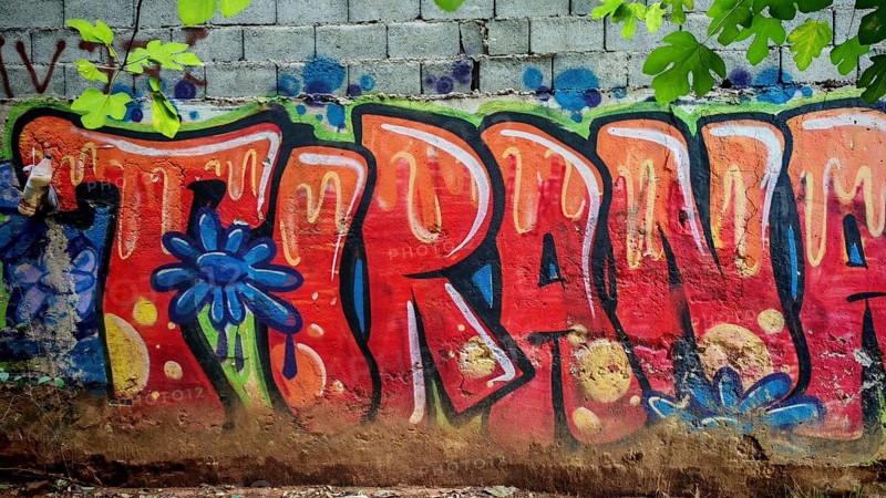 Graffiti with eye-catching colorful letters on a wall in an urban environment, city name Tirana, Tirana, Albania