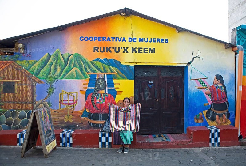 Colourfully painted house facade of a woman's cooperative in San Juan la Laguna, Atitlán, Sololá Department, Guatemala