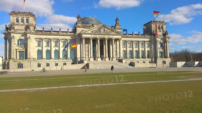 The Reichstag building in Berlin under a clear, blue sky, deserted, without people during corona, Berlin