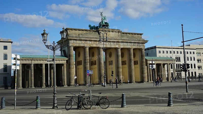 Famous gate in Berlin, Brandenburg Gate with a few bicycles in the foreground and blue sky, deserted during corona, Berlin