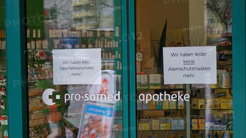 Pharmacy entrance with signs about missing disinfectants and protective masks, during corona, Berlin