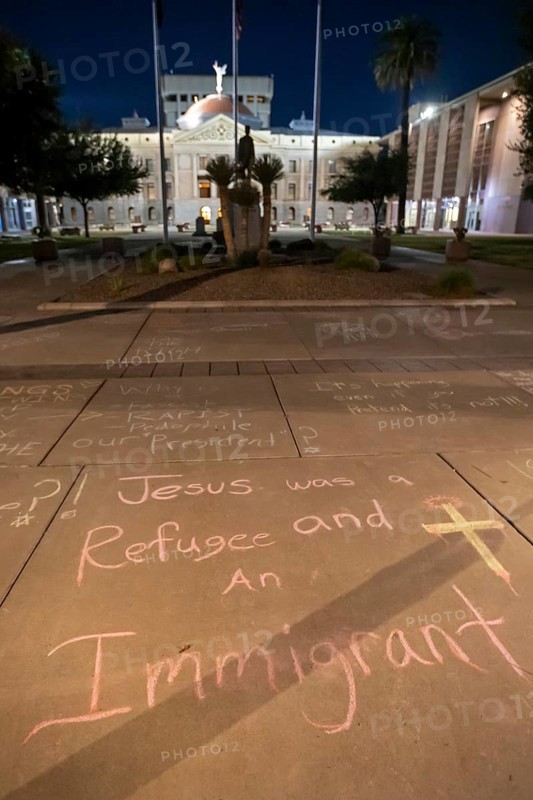 Phoenix, Arizona - Messages written in chalk on the sidewalk at the Arizona State Capitol during a protest against ICE and immigrant deportations. The messages were washed away the following morning, only steps away from a monument honoring the Bill of Rights' first amendment