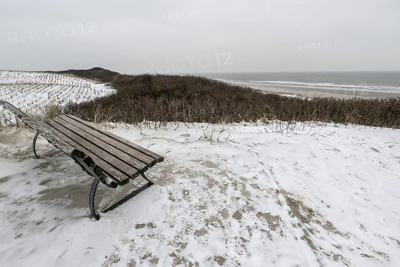 Bench in snowy dune landscape, Langeoog, Lower Saxony, Germany