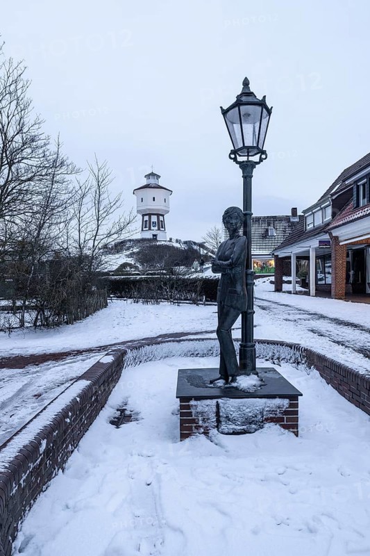 Water tower and Lale Andersen sculpture in snow, Langeoog, Lower Saxony, Germany