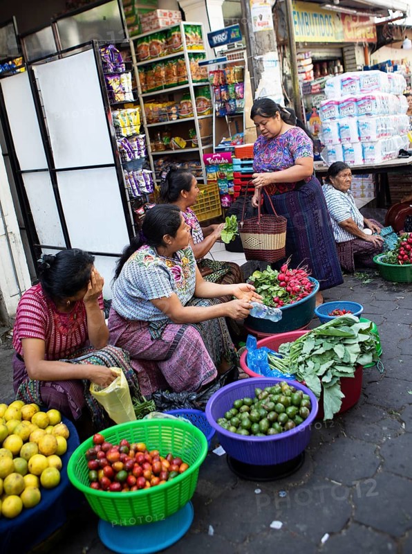 Mayan woman wearing traditional clothes selling vegetables in Santiago de Atitlán, Sololá Department, Guatemala
