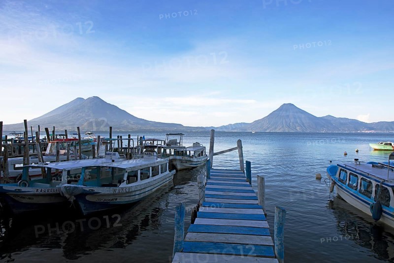 Boats on the pier, Lake Atitlán or Lake Atitlán in the morning, the volcanoes San Pedro, Atitlán and Toliman in the back, Panajachel, Sololá Department, Guatemala