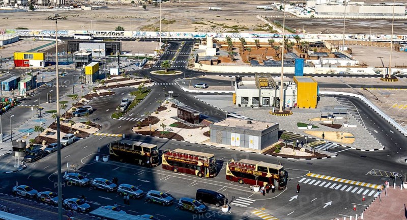 Taxi and hop on hop off buses are waiting for tourists in the cruise terminal parking lot, Abu Dhabi, UAE, United Arab Emirates