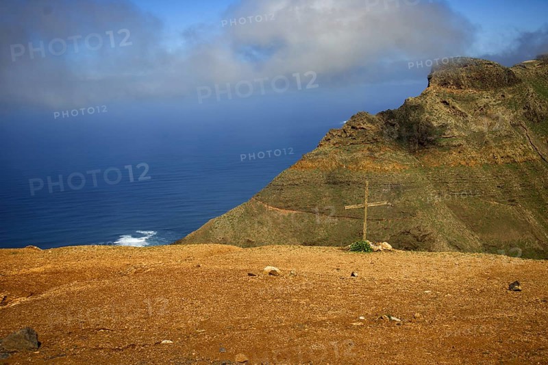 Rocky cliff with a cross in the ground, sea and clouds in the background, Mirador de Ermita de Las Nieves, Lanzarote