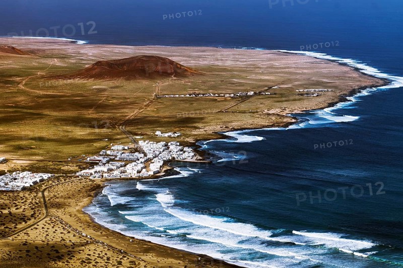Coastal village of Caleta de Famara on a winding coast with waves and sweeping skies, Mirador de Ermita de Las Nieves, Lanzarote