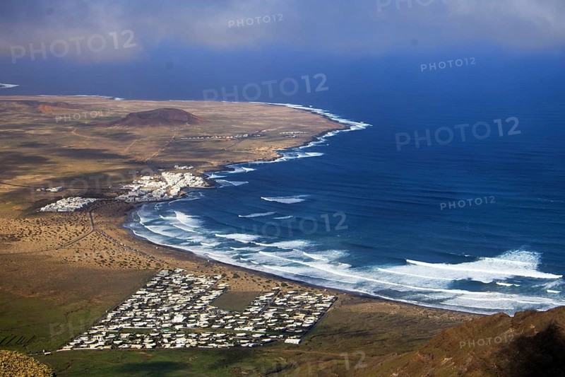 Wide coastline with bright waves and the seaside village of Caleta de Famara by the sea, Mirador de Ermita de Las Nieves, Lanzarote