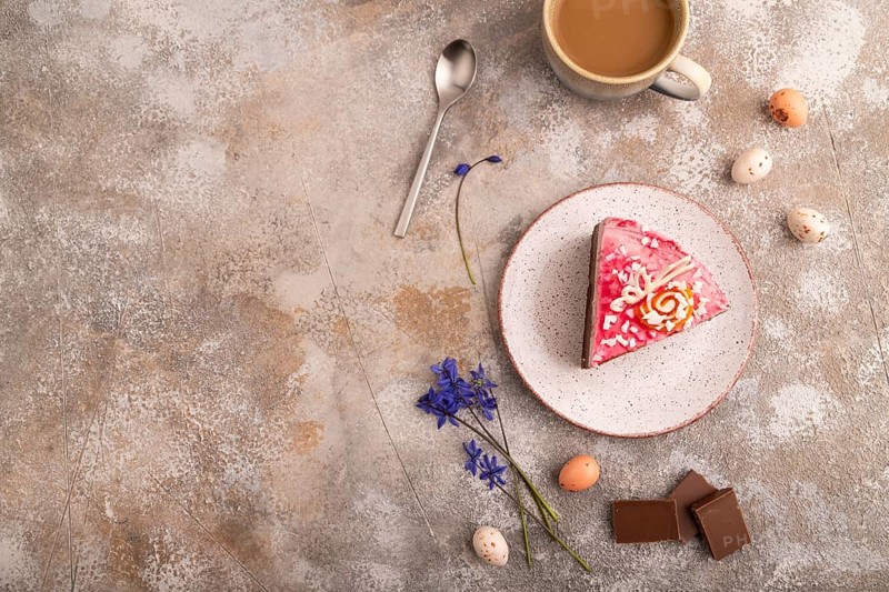 Chocolate cake on brown concrete background, cup of coffee, top view, flat lay, copy space