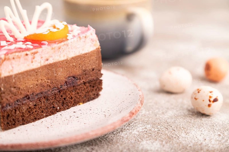 Chocolate cake on brown concrete background, cup of coffee, side view, close up, selective focus