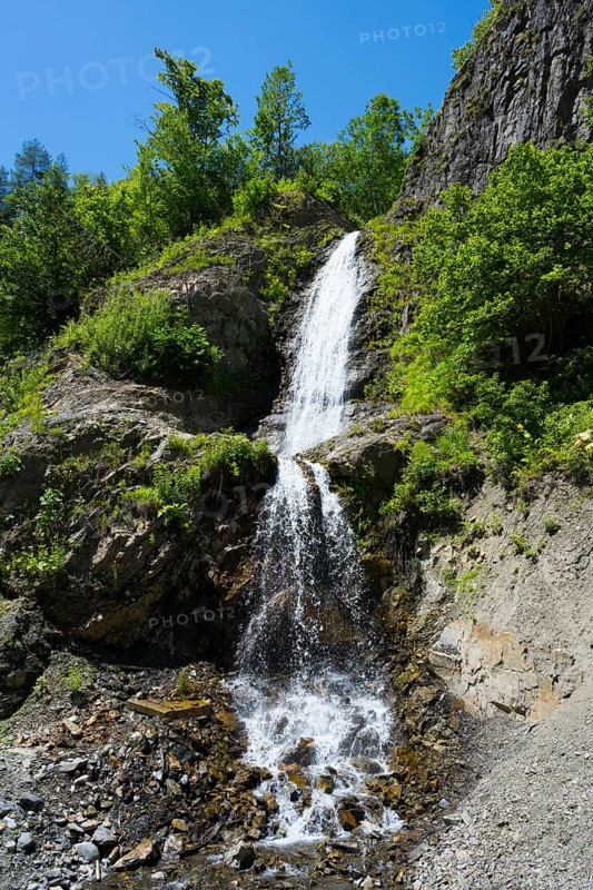 Small waterfall falling over green rocks, waterfall near Dizi, road 7, Mingrelia and Upper Svaneti region, High Caucasus, Georgia