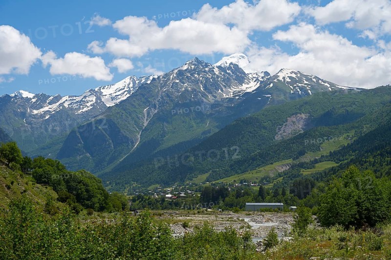 Majestic snow-capped mountains under a cloudy sky, view from Majvdieri of Mount Tetnuldi, Mestia Municipality, Mulkhra River, Road 7, Mingrelia and Upper Svaneti Region, High Caucasus, Georgia