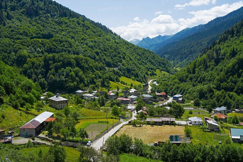 Village nestled in a green valley with mountains in the background, Bogreshi, road 7, Mingrelia and Upper Svaneti region, High Caucasus, Georgia