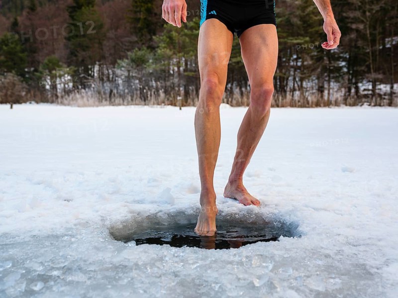 Naked men's legs at an ice hole, toes in water, Thumsee, Bad Reichenhall, Berchtesgadener Land, Upper Bavaria, Bavaria, Germany