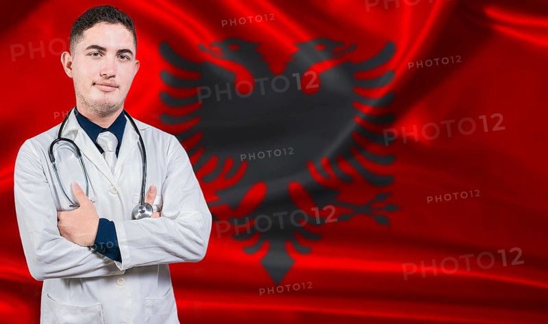 Portrait of medical professional on Albania flag background. Albanian national health system