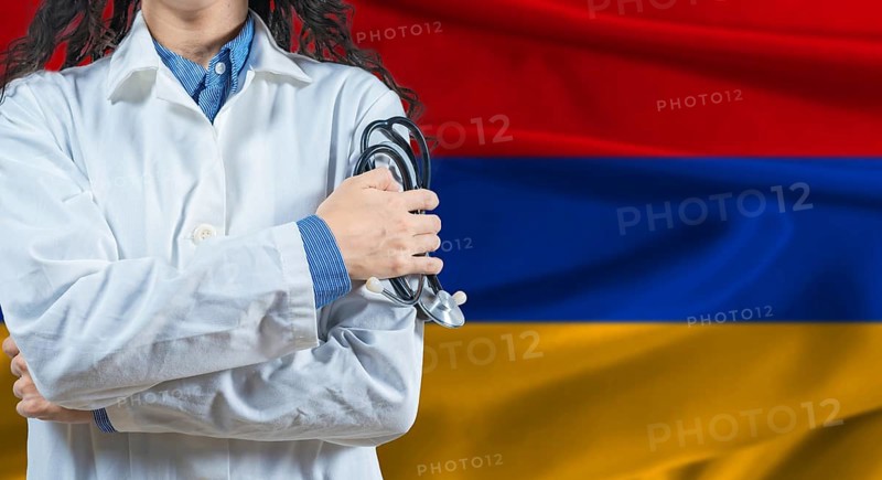 Healthcare professional with Armenia flag background. Professional doctor holding stethoscope on Armenia flag background