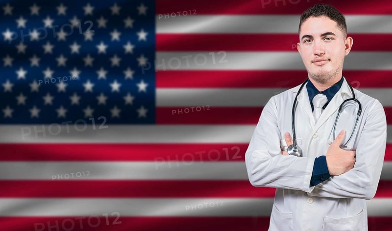 Portrait of medical professional on United States flag background. American national health system