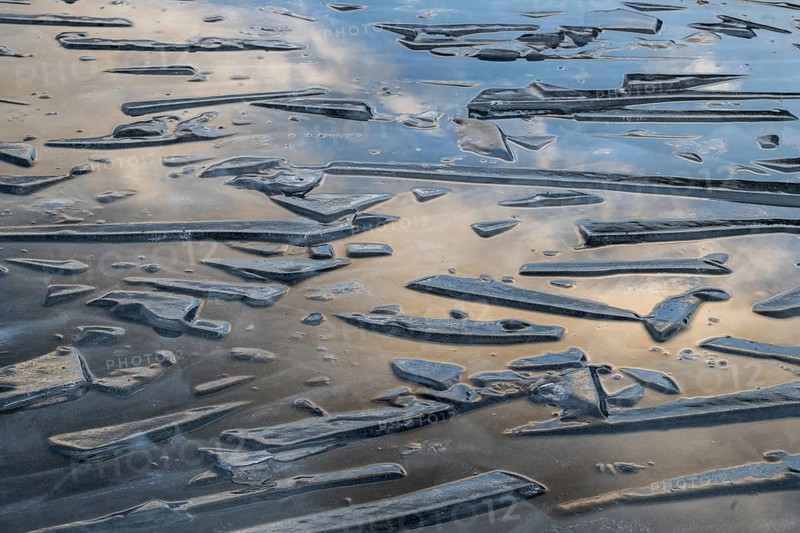 Pieces of ice and clouds reflecting on the water surface, lake, winter, Finland