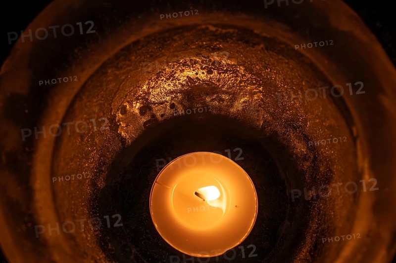 Burning tea light in a bowl of ice, winter, Finland