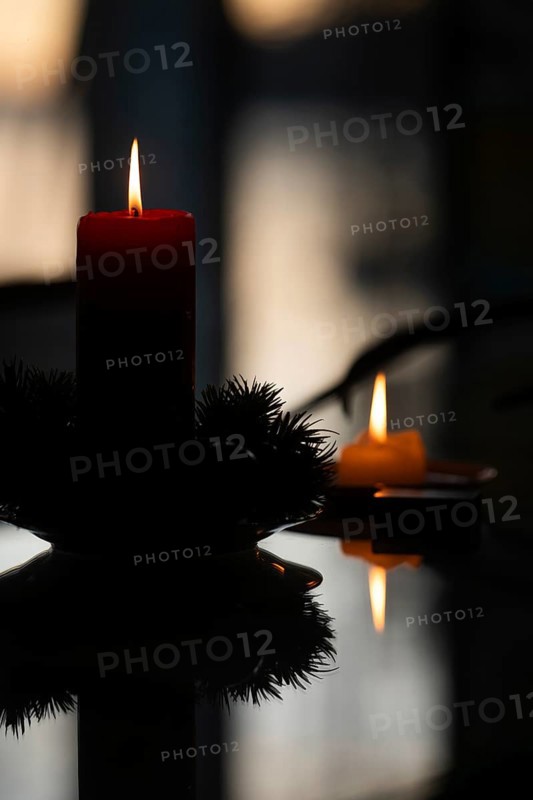 Two candles stand on a table in front of a window at dusk and create a Christmas atmosphere, Finland