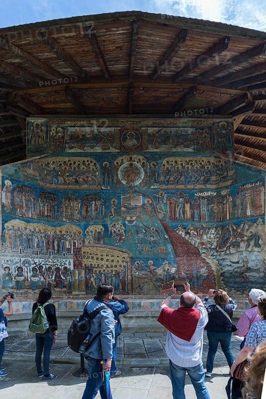 Tourists photograph the Last Judgment frescoes, Vorone? Monastery Church, 1547, Vorone?, Romania
