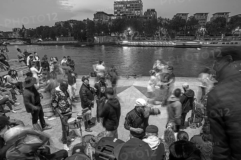 Music and dance by young people in the evenings on the Seine, black and white, Paris, France