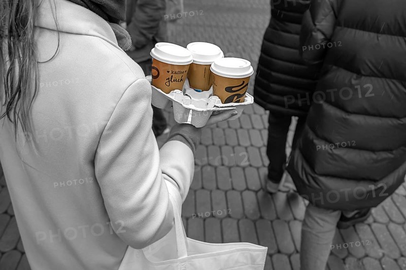 Lady carrying three coffees to go on the street, black and white, Nuremberg, Middle Franconia, Bavaria, Germany