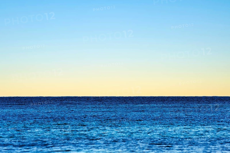 Minimalist illustration, horizon over the sea, clear evening sky, various shades of blue, calm water surface, background picture, seaside resort Mondello, Palermo, Sicily, north coast, Tyrrhenian Sea, Italy