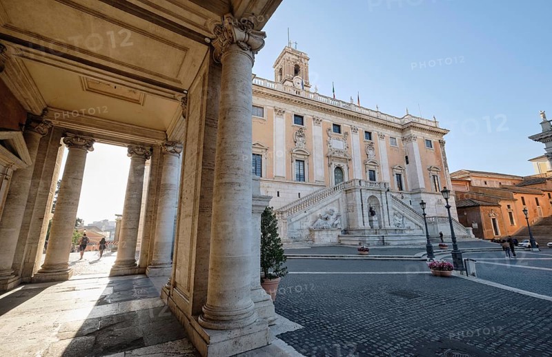 Arcade, columns of the Palazzo Nuovo in the morning light, Senators' Palace (Palazzo Senatorio) in the background, Piazza del Campidoglio on the Capitoline Hill, Capitoline Square, Rome, Lazio, Italy