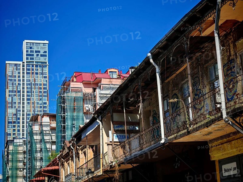 Modern and old architecture contrasting under clear skies, Batumi, Georgia