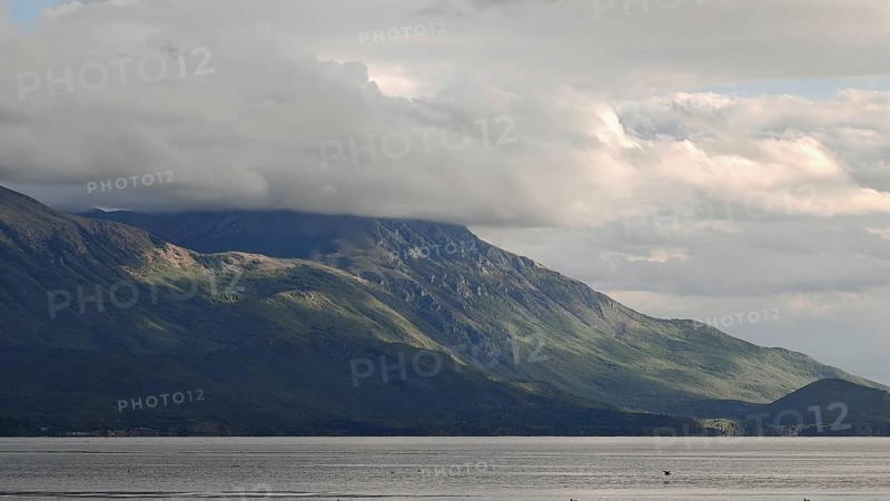Landscape view of hills under a cloud cover, bordering a lake, Lake Ohrid, North Macedonia