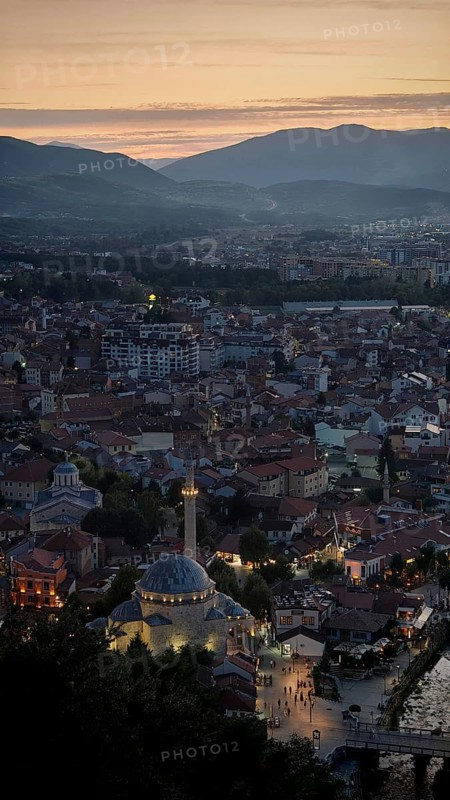 A view of the city at dusk dominated by a mosque and surrounded by mountains, Prizren, Kosovo