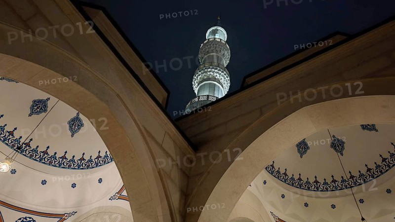 Night view of a mosque with minaret and ornamental arches, Tirana, Albania