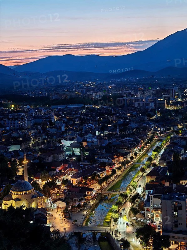Nighttime city view with illuminated river and adjacent architecture, Prizren, Kosovo