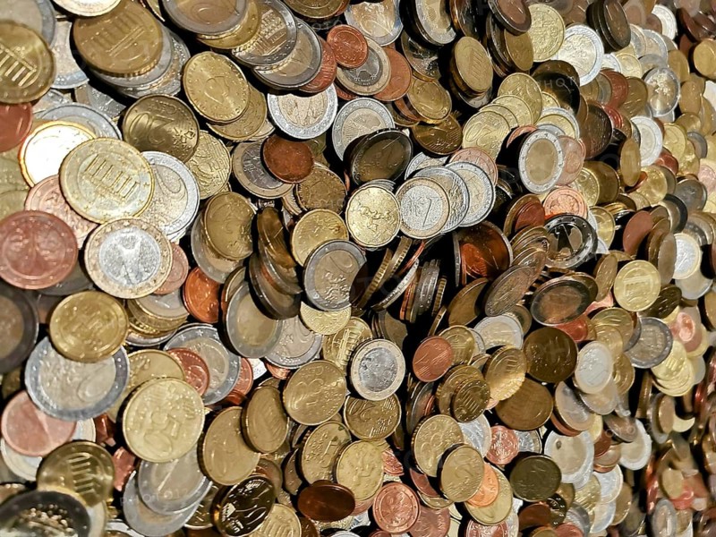 Different coins in a colorful collection in a heap