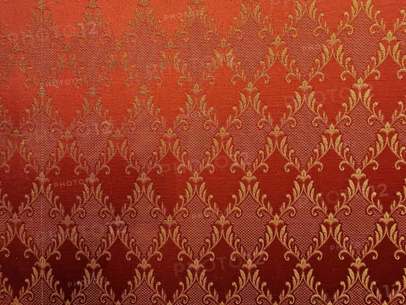 Red fabric with golden, ornamental damask pattern