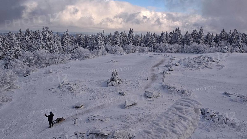 Snowy landscape with a wide view under blue, cloudy sky. Lonely and quiet, Schneeberg, Fichtelgebirge, Bavaria