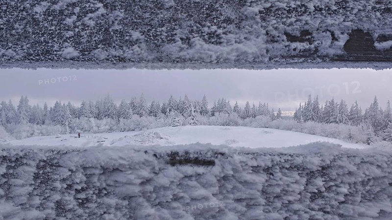 Snowy landscape with views of a forest from the viewpoint. Quiet, cold atmosphere, Schneeberg, Fichtelgebirge, Bavaria