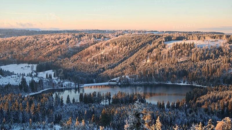 View of a snow-covered forest and lake during sunset, Rennsteig, Thuringian Forest