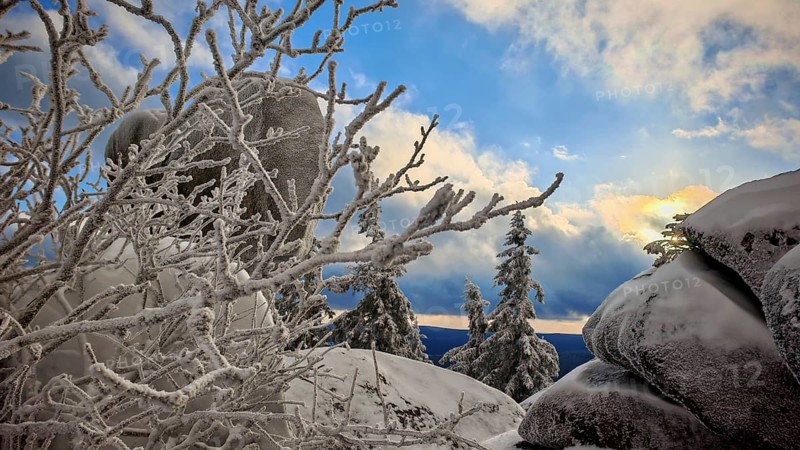Snowy rocks and trees with a dramatic evening sky, Fichtelgebirge, Bavaria