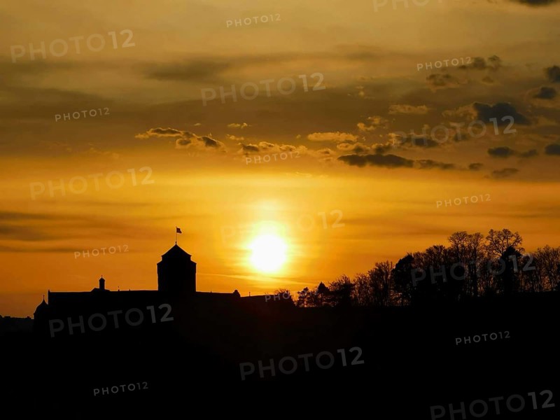 Silhouette of a castle in front of a glowing sunset