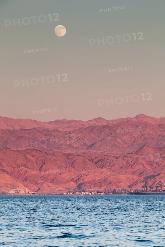 Eilat, Israel, Middle East. From across the red sea in Eilat Aqaba in Jordan on the opposite side of the bank during a full moon